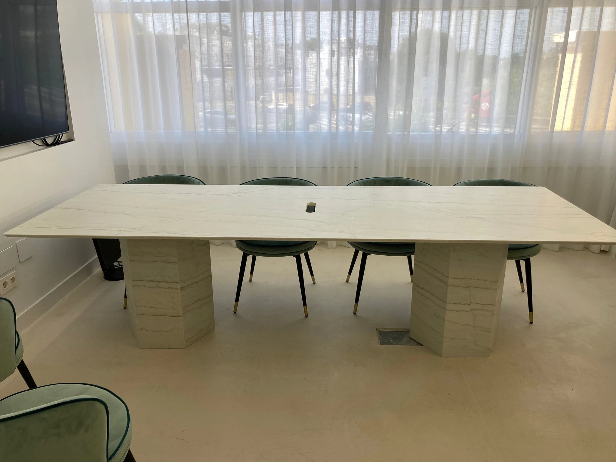 Dekton Neural conference table with white marble-look finish and cylindrical stone pedestals — premium dekton surfaces fabricated and installed by Signature ...