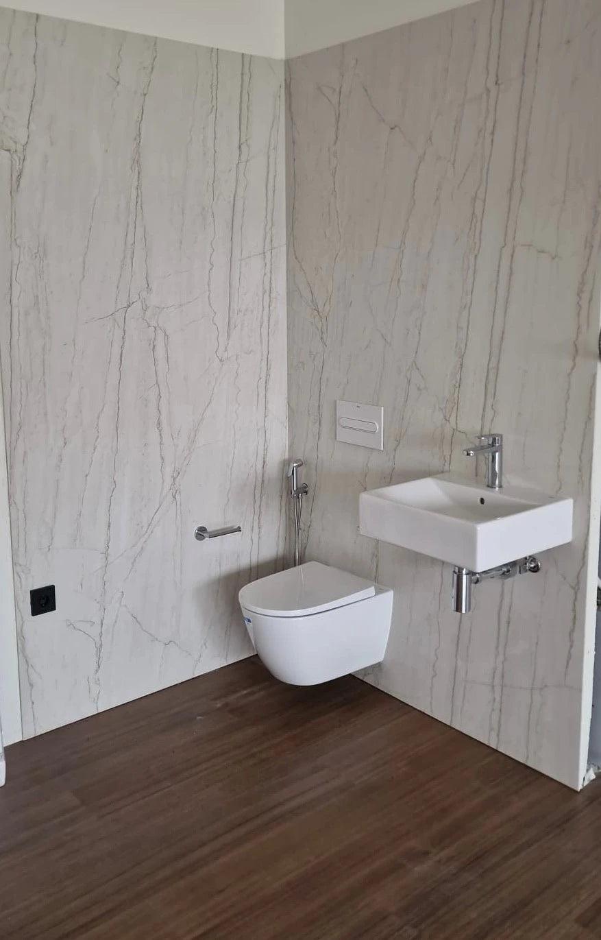 Dekton Neural bathroom wall cladding with white marble-look veining and matte finish — premium dekton countertops installed by Signature Stone Las Vegas