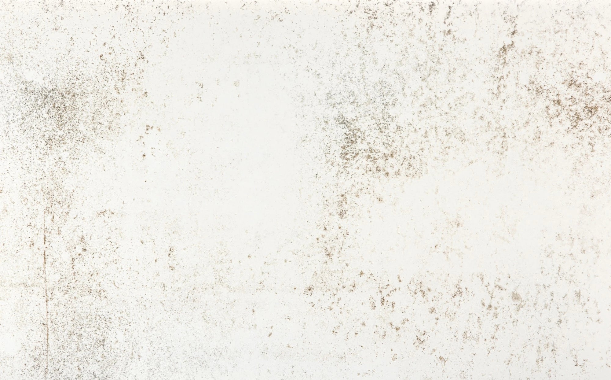 Dekton Nilium surface with light cream background and subtle brown speckled texture — premium dekton countertops installed by Signature Stone Las Vegas
