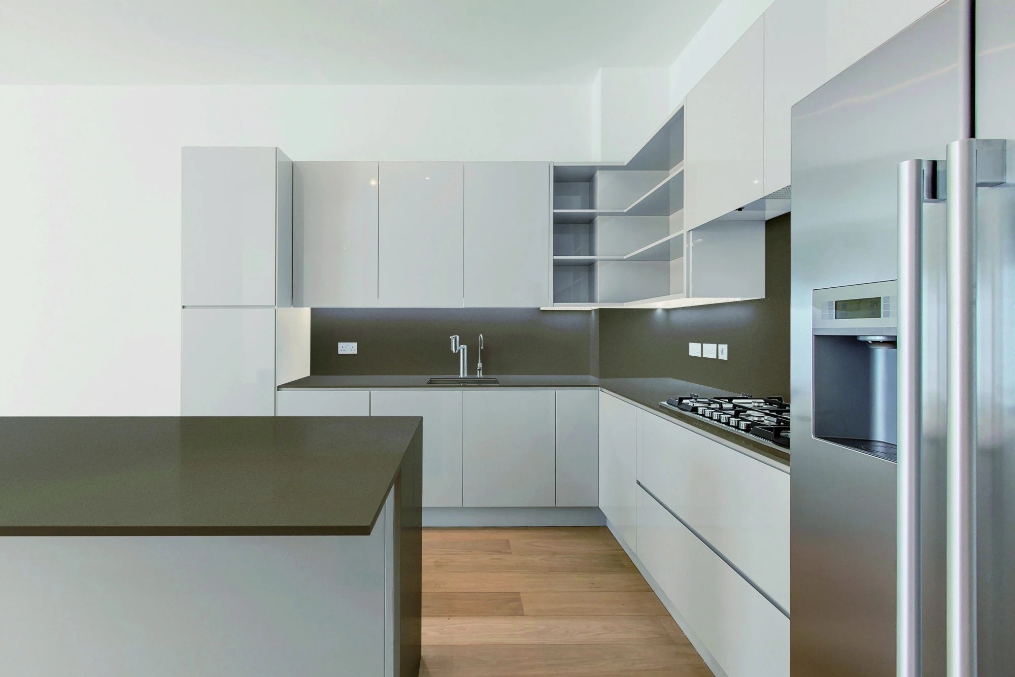 Silestone Noka quartz kitchen countertops with dark olive backsplash and white cabinetry — quartz countertops near me by Signature Stone Las Vegas