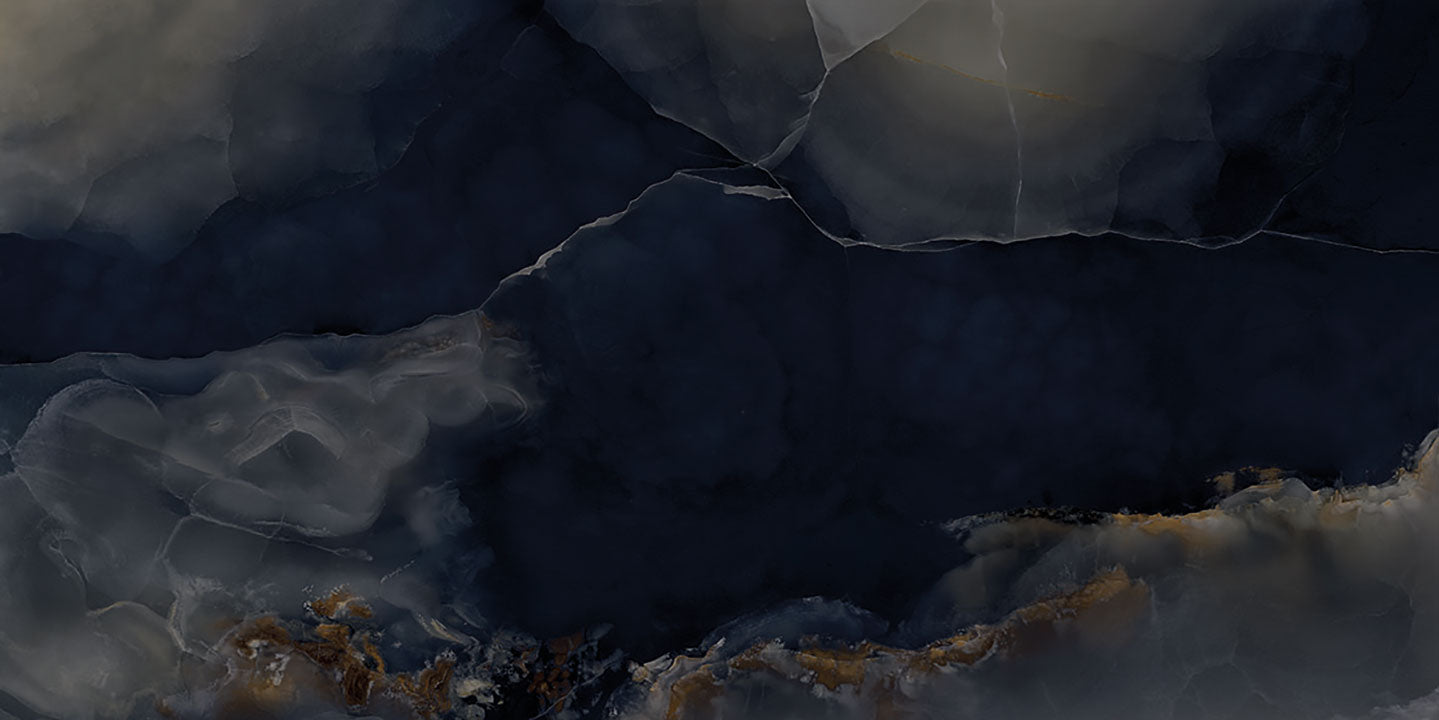 Onyx Misterioso slab with dramatic dark blue and gray veining with gold accents — custom countertops fabricated and installed by Signature Stone LV