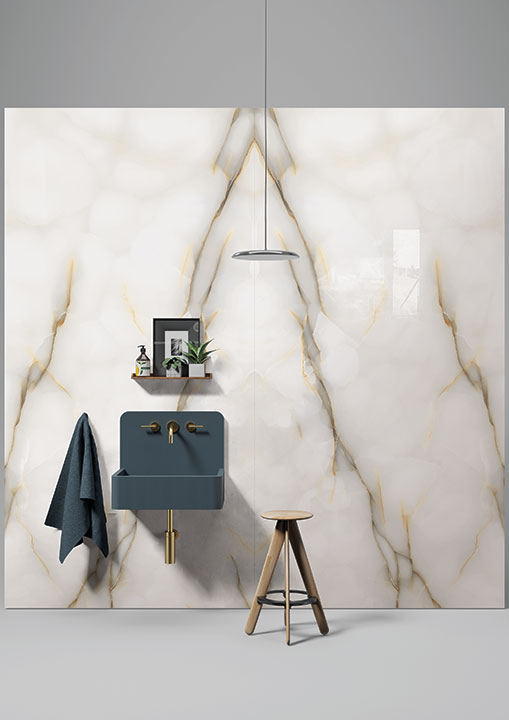 Onyx Perla bathroom vanity with white marble veining and gold fixtures — custom countertops fabricated and installed by Signature Stone LV