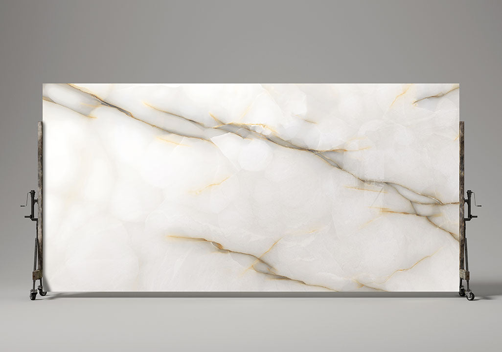 Onyx Perla slab with white base and golden veining displayed on metal stand — elegant stone countertops installed by Signature Stone Las Vegas