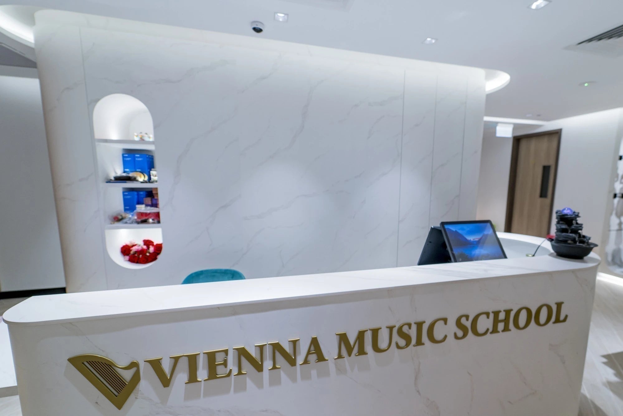 Dekton Opera reception desk with white marble-look finish and curved edges — premium dekton surfaces fabricated and installed by Signature Stone LV