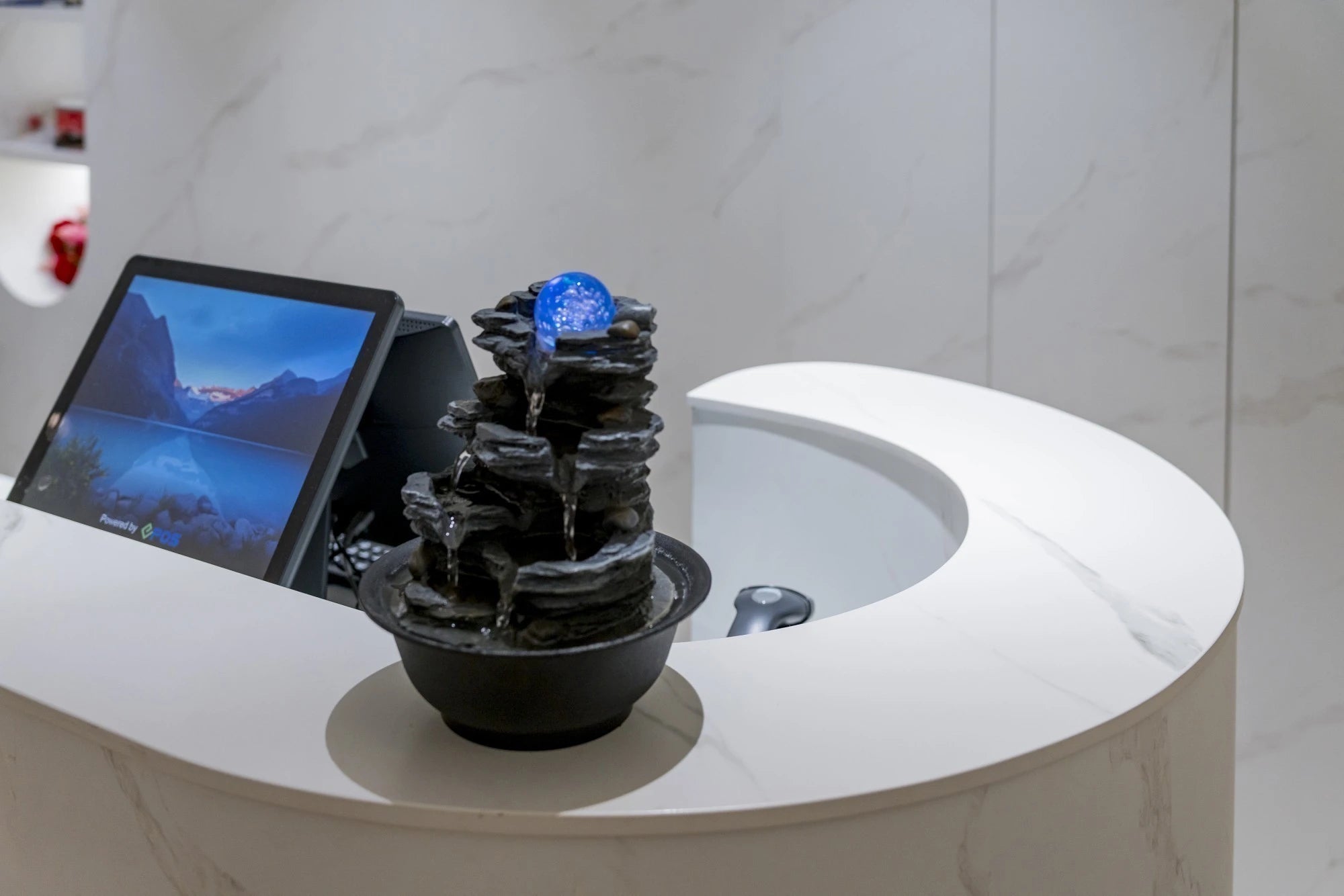 Dekton Opera countertop surface with white curved edge and dark stone fountain feature — premium dekton kitchen countertops by Signature Stone Las Vegas