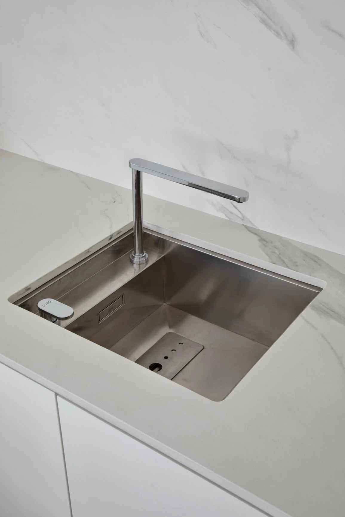 Dekton Opera kitchen island with white marble-look finish and undermount stainless steel sink — dekton kitchen countertops by Signature Stone Las Vegas