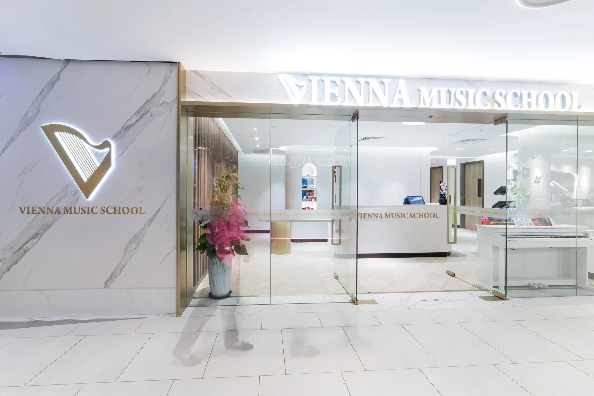 Dekton Opera wall cladding with white marble veining and gold trim accents — premium dekton surfaces fabricated and installed by Signature Stone LV