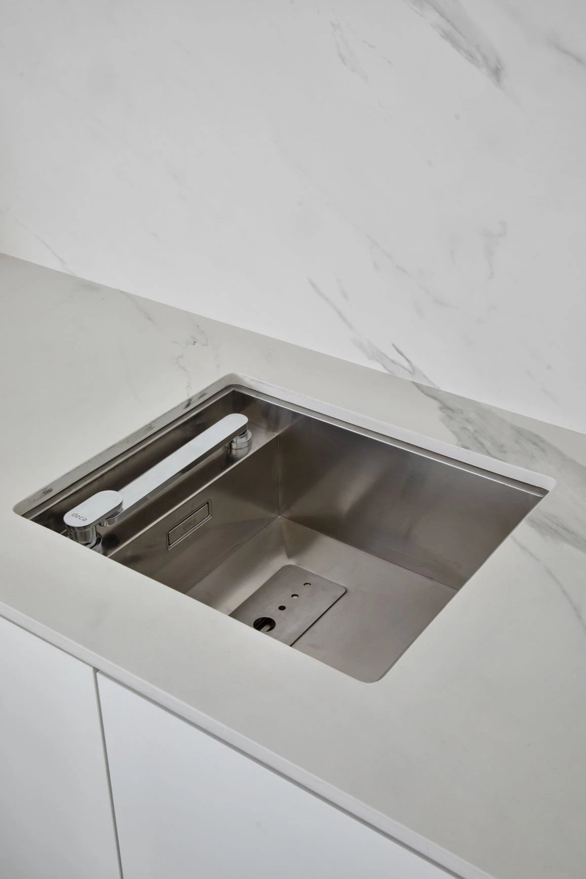 Dekton Opera kitchen countertop with undermount sink, white marble-look finish and clean edges — premium dekton surfaces fabricated and installed by Signatur...