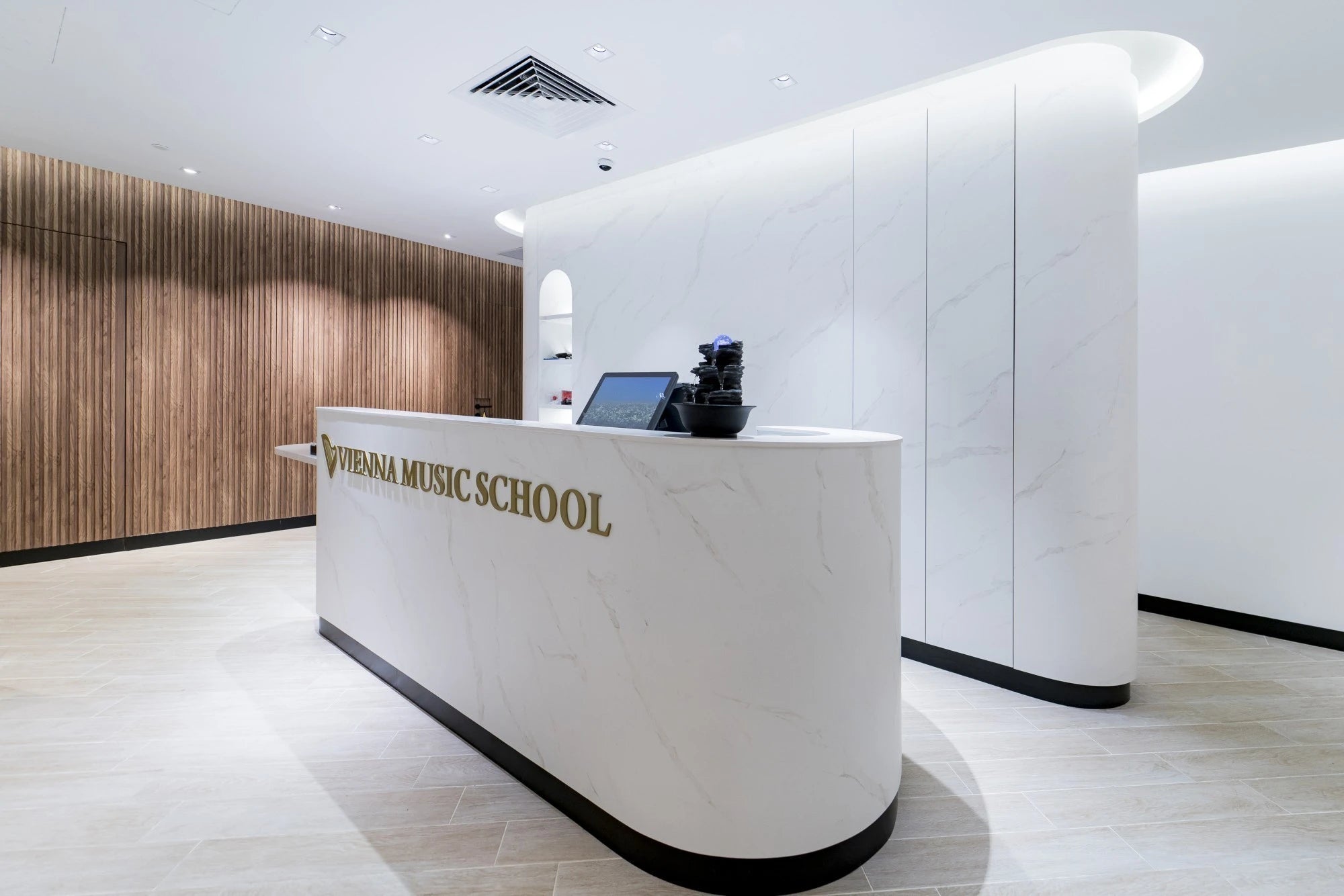 Dekton Opera reception desk with white marble-look finish and curved edges — elegant dekton kitchen countertops by Signature Stone Las Vegas
