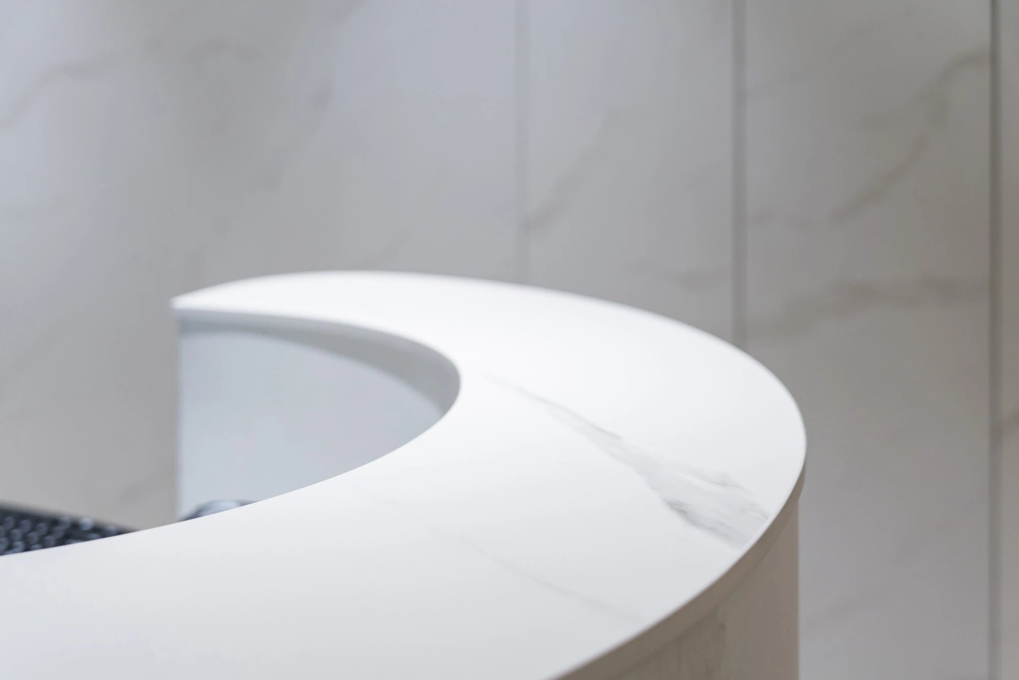 Dekton Opera curved countertop surface with smooth white finish and rounded edge — premium dekton countertops installed by Signature Stone Las Vegas