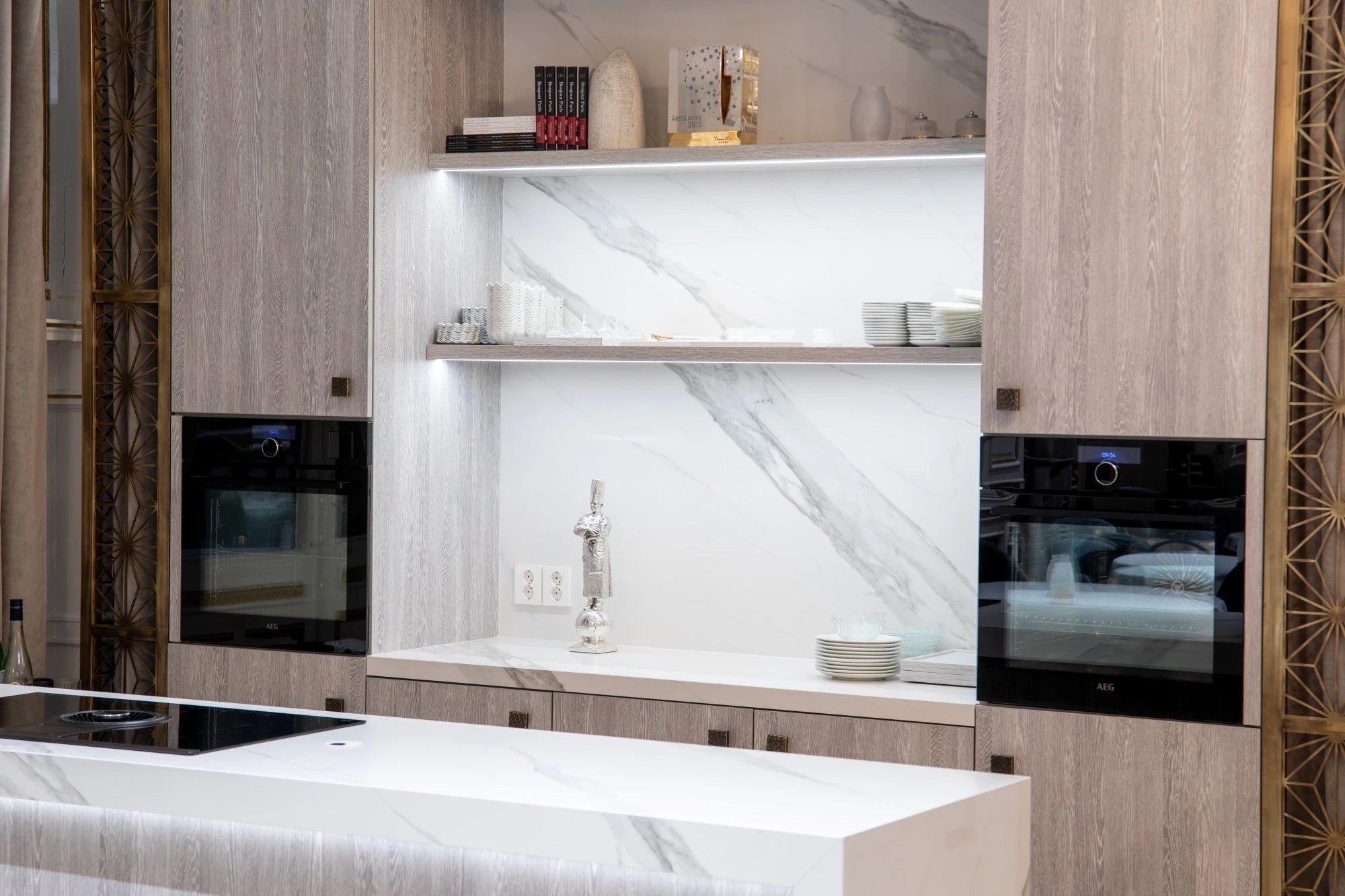 Dekton Opera kitchen island and backsplash with white marble-look veining and matching cabinetry — premium dekton kitchen countertops by Signature Stone Las ...