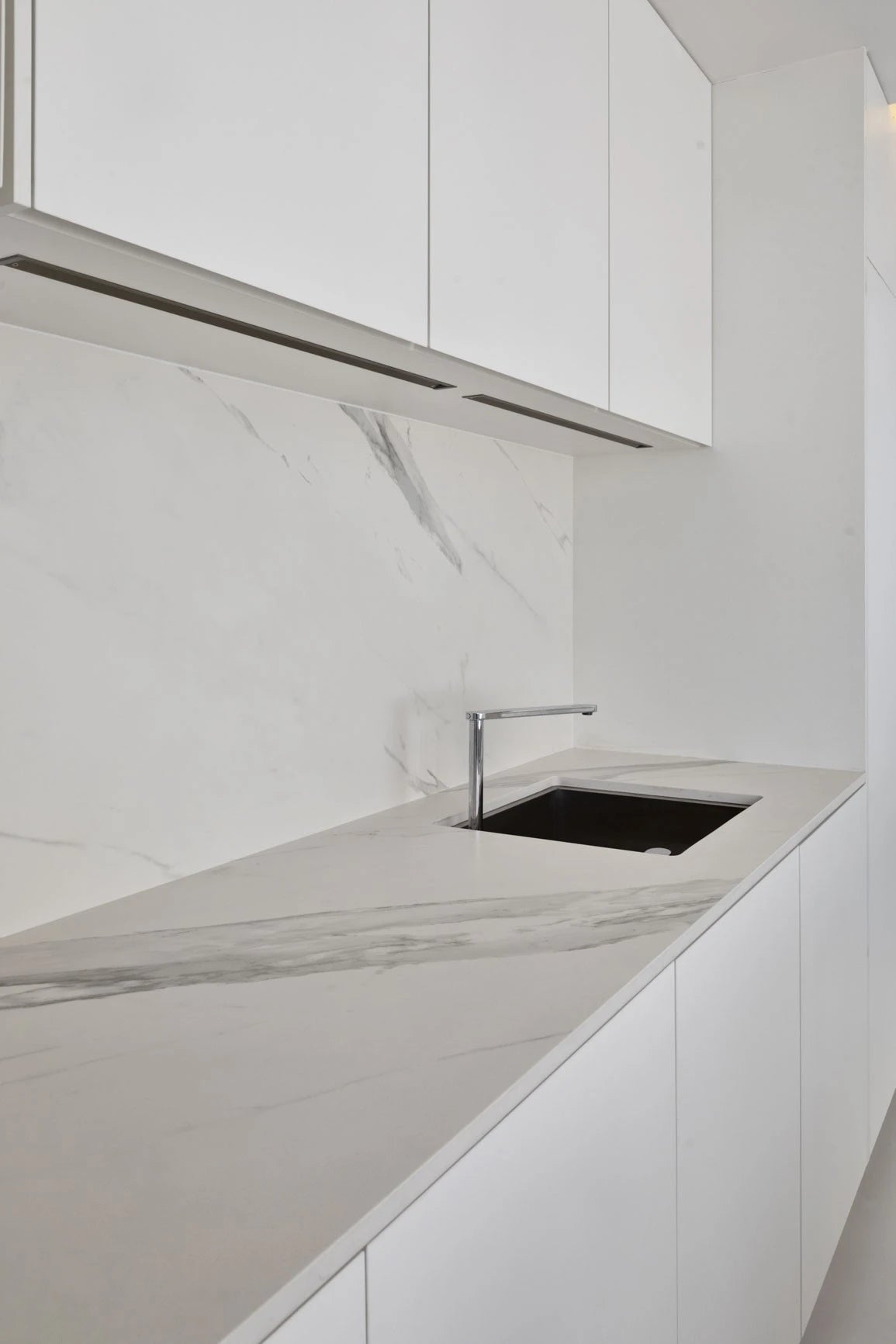 Dekton Opera kitchen surfaces with white marble-look veining and modern chrome faucet — premium dekton kitchen countertops by Signature Stone Las Vegas