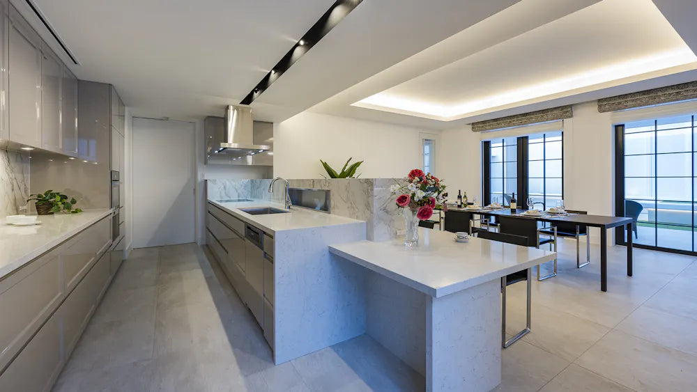 Silestone Pearl Jasmine kitchen island with polished white finish and waterfall edge — quartz countertops installed by Signature Stone Las Vegas