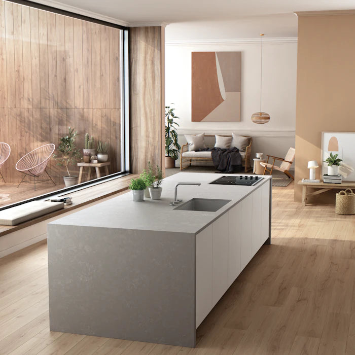 Silestone Poblenou kitchen island with smooth gray finish and integrated cooktop — engineered quartz countertops fabricated and installed by Signature Stone LV