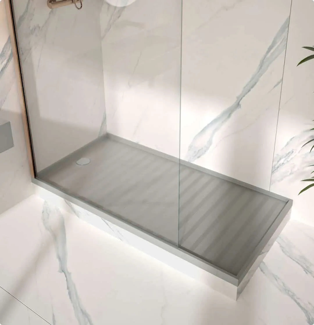 Silestone quartz shower tray with gray finish and glass enclosure in marble-walled bathroom — quartz countertops installed by Signature Stone Las Vegas
