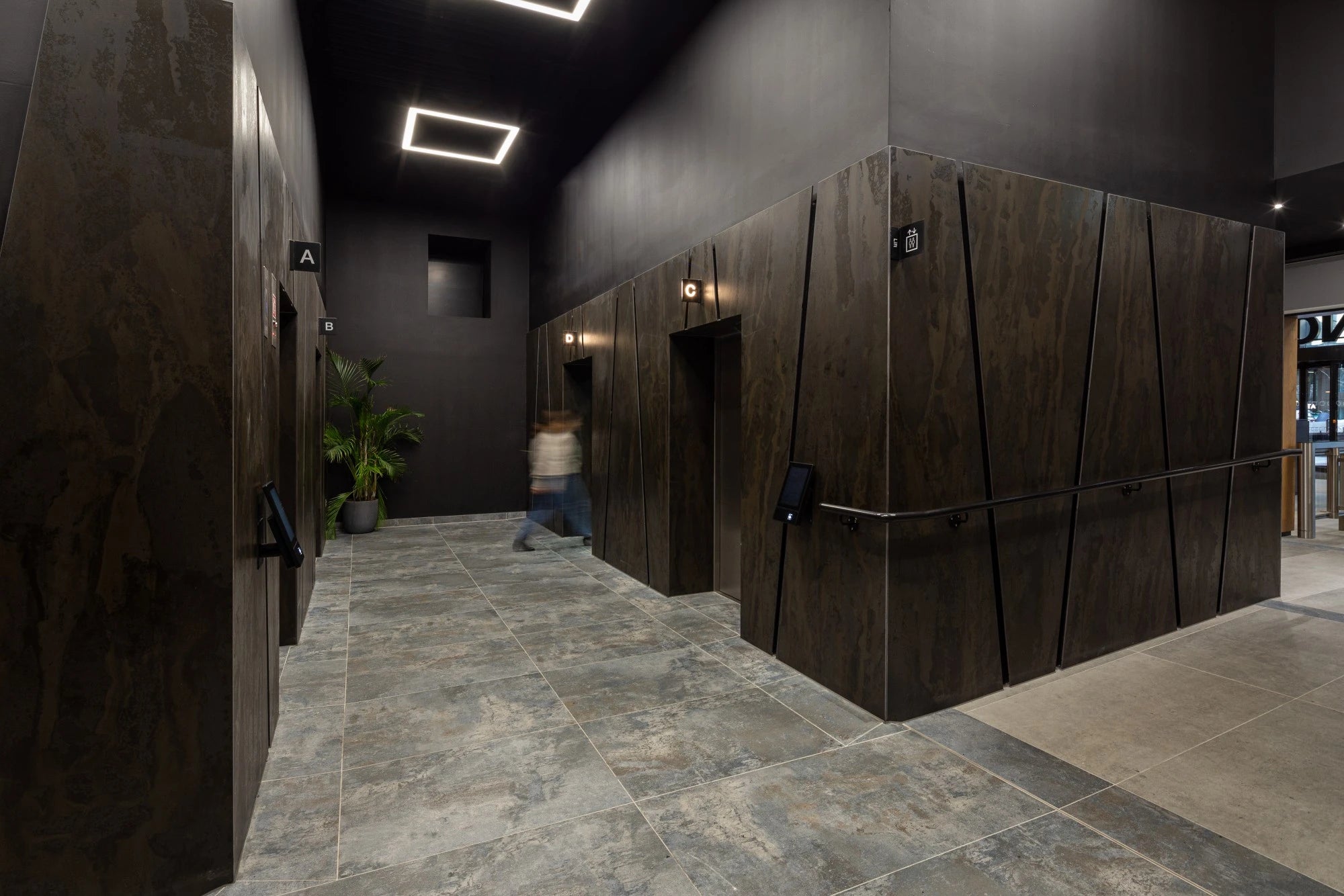 Dekton Radium wall cladding with dark wood grain pattern and angular geometric design — dekton countertops installed by Signature Stone Las Vegas
