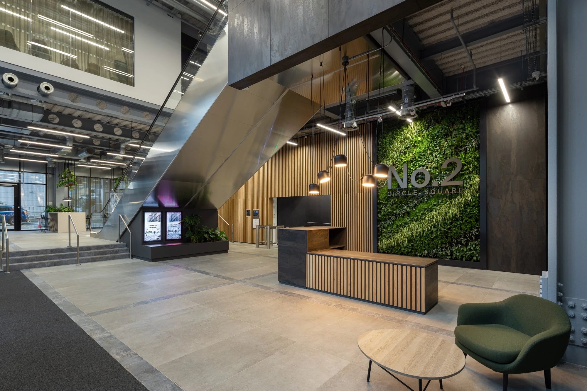 Dekton Radium commercial reception desk with dark matte finish and wood accents — premium dekton surfaces fabricated and installed by Signature Stone LV