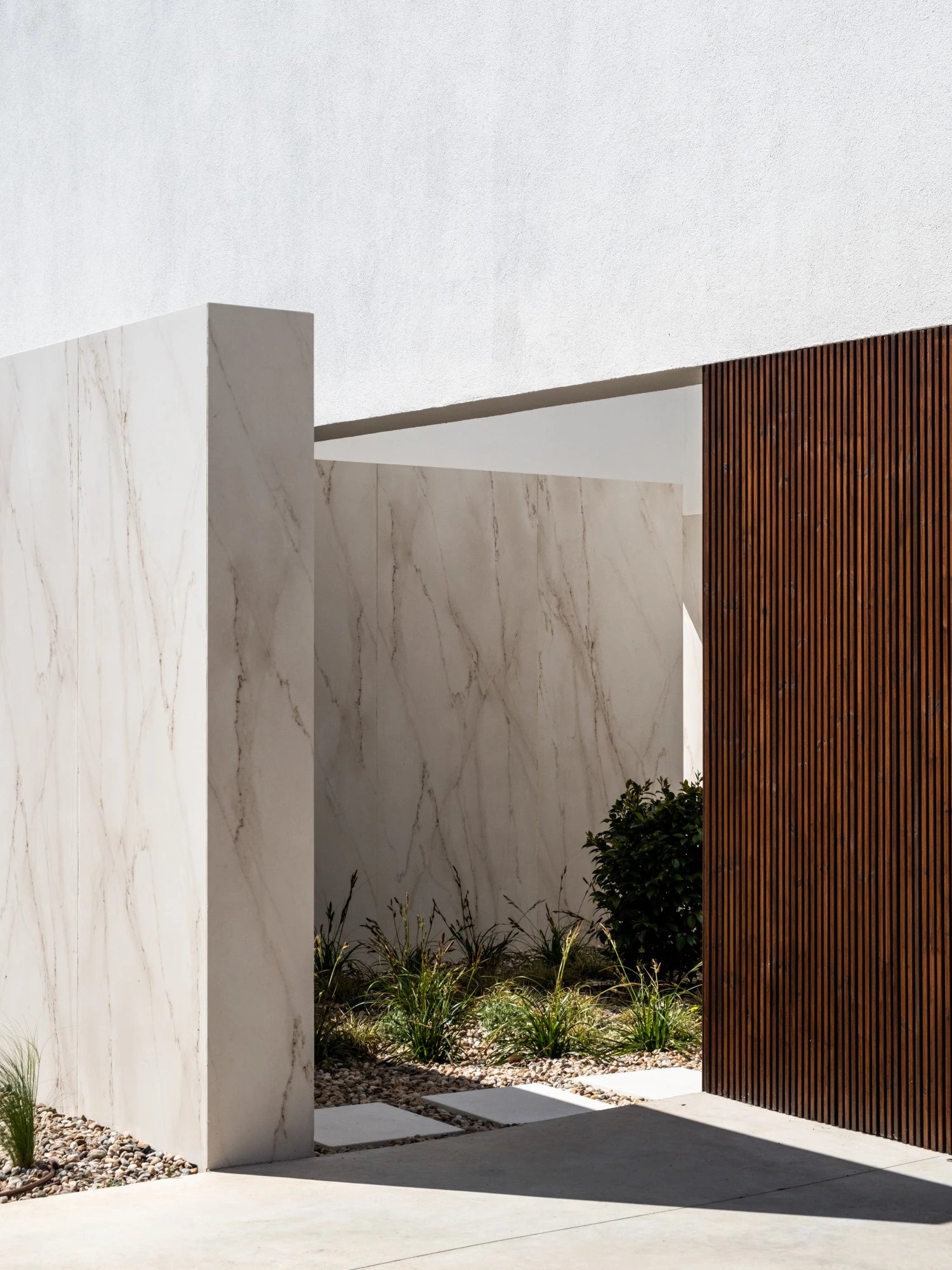 Dekton Rem exterior wall cladding with light marble veining and matte finish — premium dekton surfaces fabricated and installed by Signature Stone LV