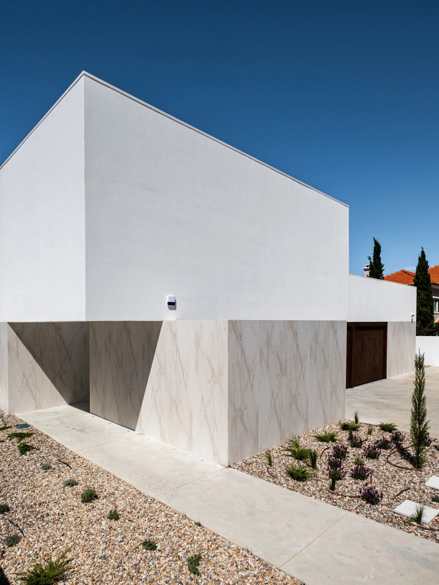 Dekton Rem exterior cladding with white marble-look veining and matte finish — premium dekton surfaces fabricated and installed by Signature Stone LV