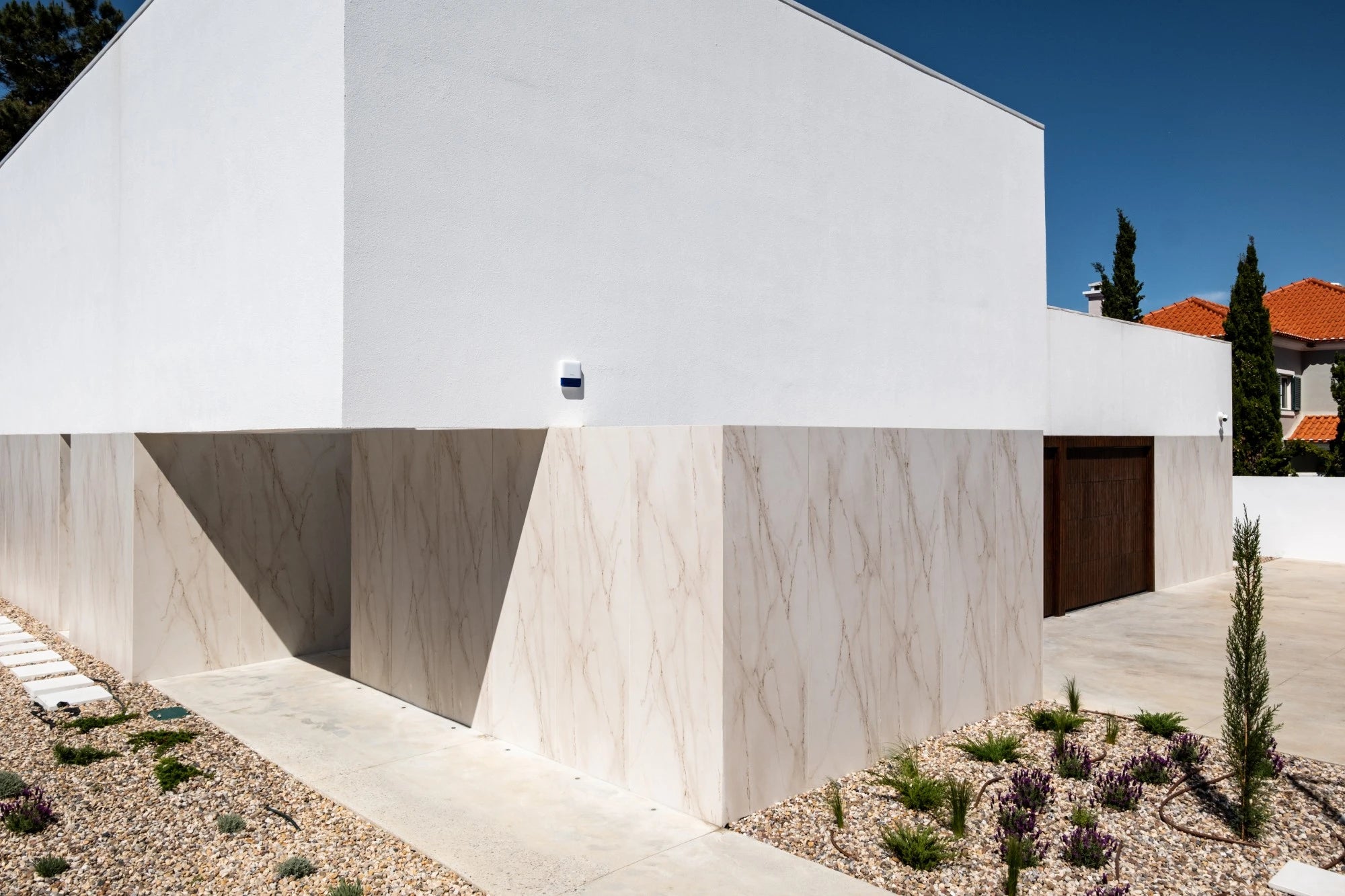 Dekton Rem exterior wall cladding with white marble-like veining and matte finish — premium dekton surfaces fabricated and installed by Signature Stone LV