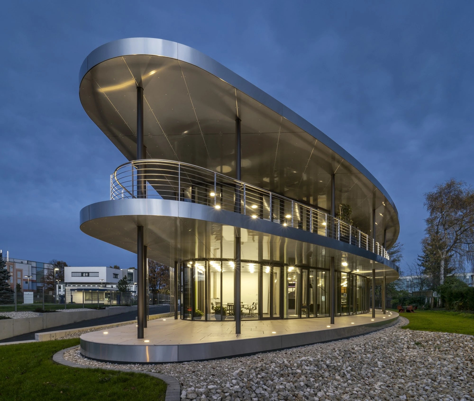 Dekton Sasea modern curved architectural facade with sleek gray finish and glass panels — premium dekton countertops installed by Signature Stone Las Vegas