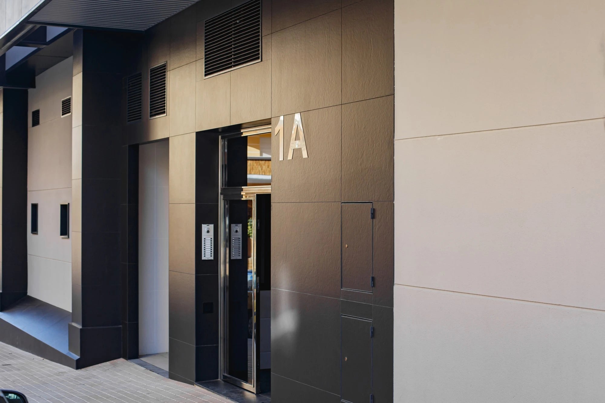 Dekton Sirius exterior wall cladding with warm beige tones and smooth matte finish — premium dekton surfaces fabricated and installed by Signature Stone LV