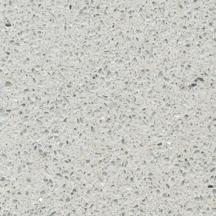 Silestone Stellar Snow surface with light gray background and scattered dark speckles in polished finish — quartz countertops installed by Signature Stone La...