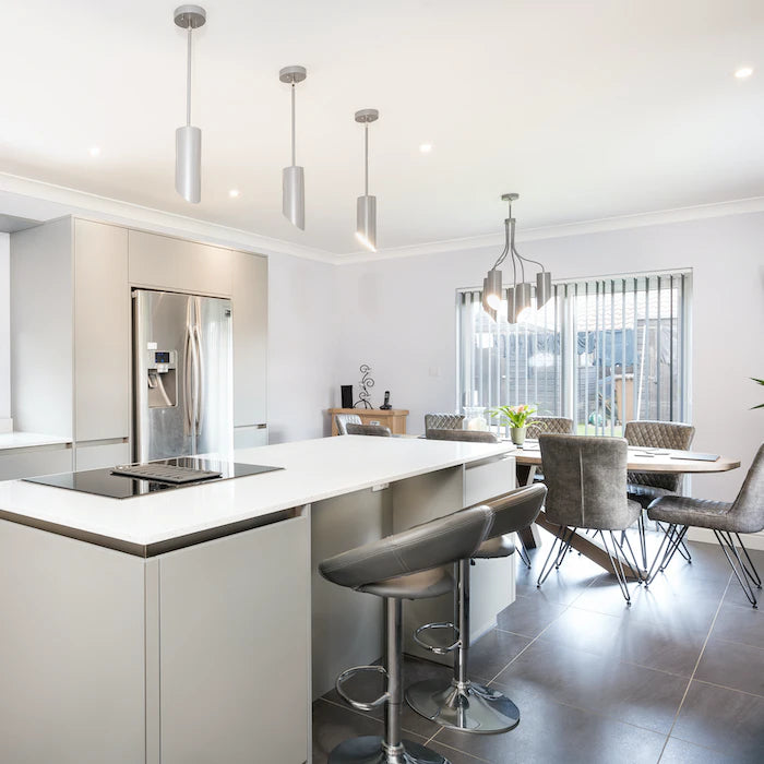 Silestone Stellar Snow kitchen island with white surface and waterfall edge — engineered quartz countertops fabricated and installed by Signature Stone LV