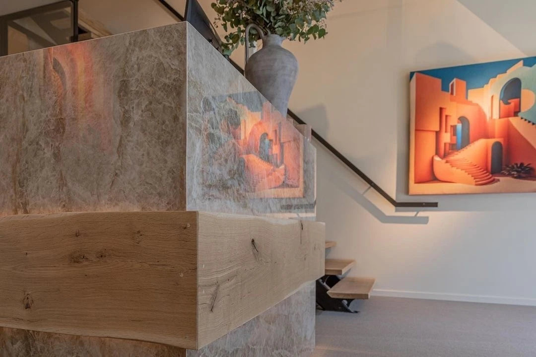 Dekton Taga staircase cladding with light marble-look finish and natural wood accents — premium dekton surfaces fabricated and installed by Signature Stone LV