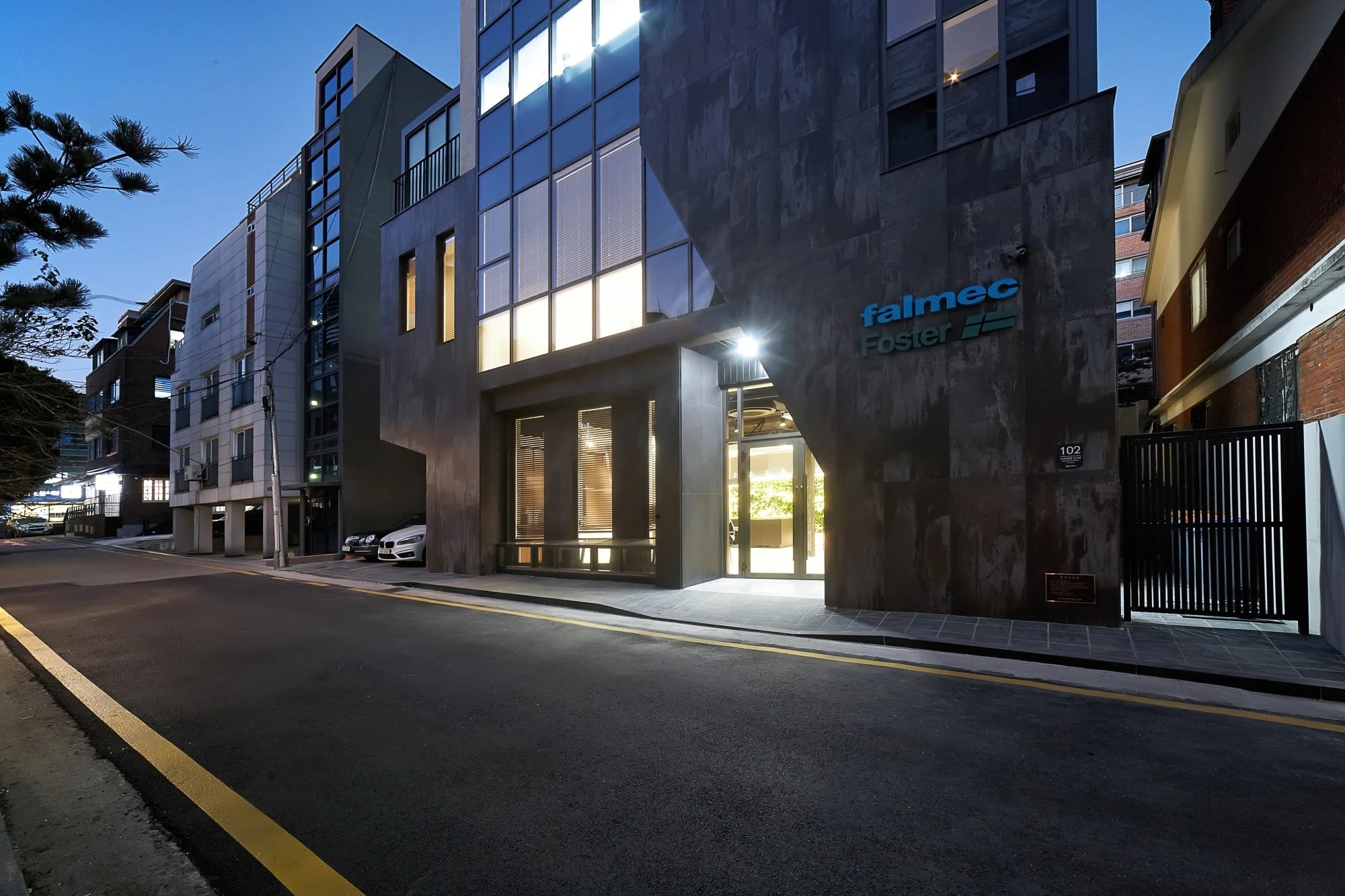 Dekton Trilium modern building facade with dark concrete finish and glass windows — dekton countertops installed by Signature Stone Las Vegas