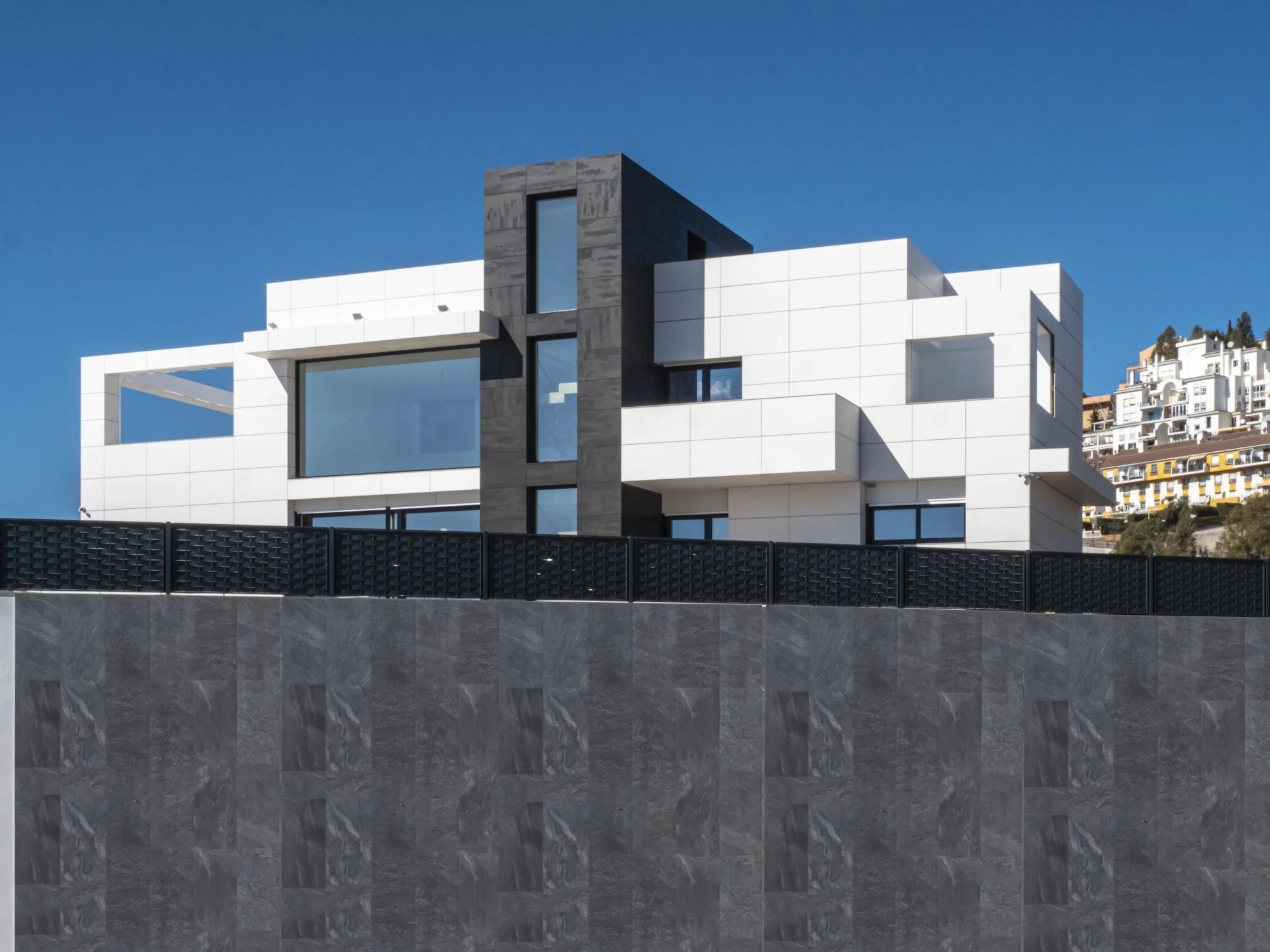 Dekton Uyuni exterior cladding with light gray marble-look finish on modern building facade — premium dekton kitchen countertops by Signature Stone Las Vegas