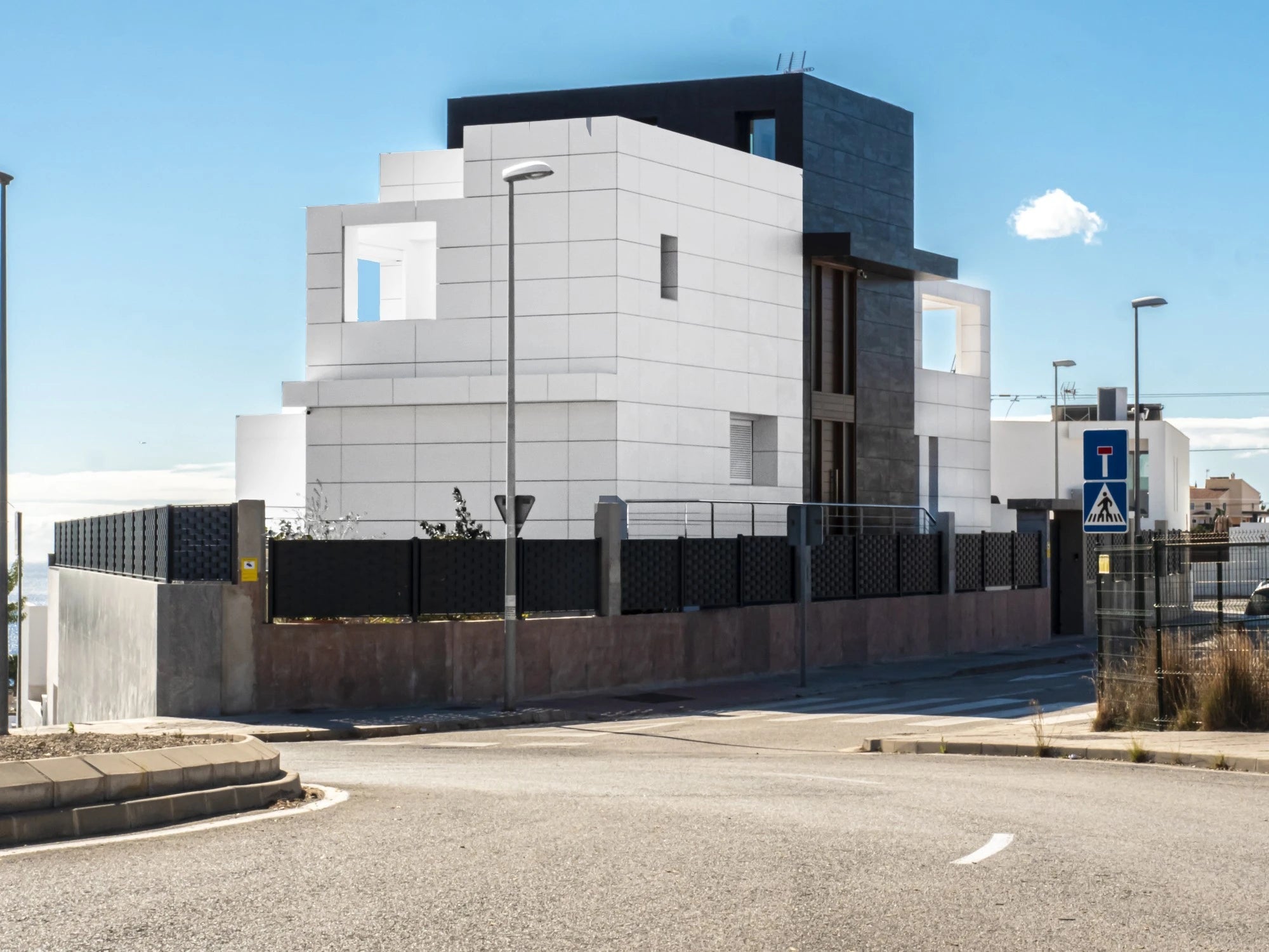 Dekton Uyuni exterior cladding with white geometric panels and dark accents — dekton countertops installed by Signature Stone Las Vegas