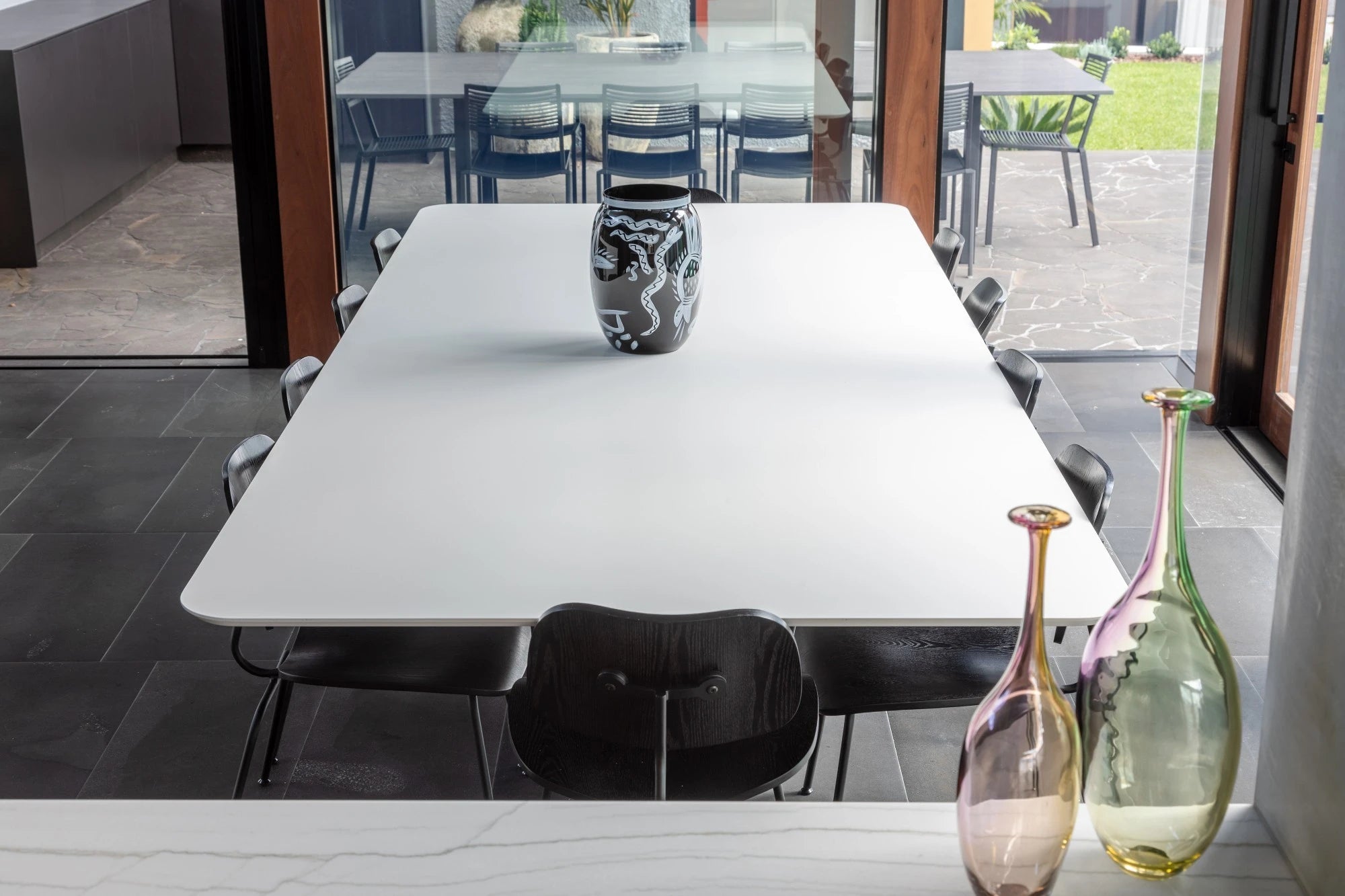 Dekton Uyuni dining table with clean white finish and modern edge detail — premium dekton surfaces fabricated and installed by Signature Stone LV