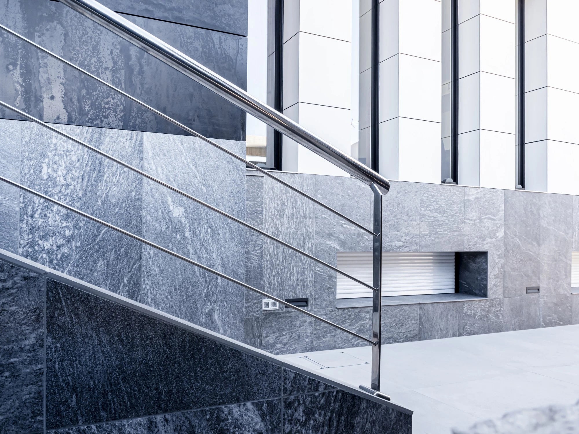 Dekton Uyuni staircase with gray veined surface and steel railings — premium dekton countertops installed by Signature Stone Las Vegas