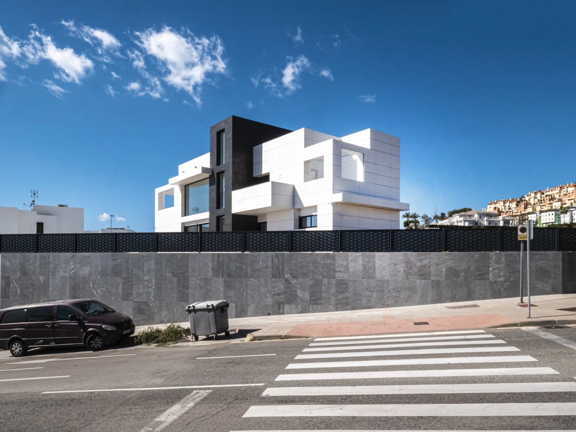 Dekton Uyuni exterior cladding with white geometric architectural panels and dark accents — premium dekton surfaces fabricated and installed by Signature Sto...