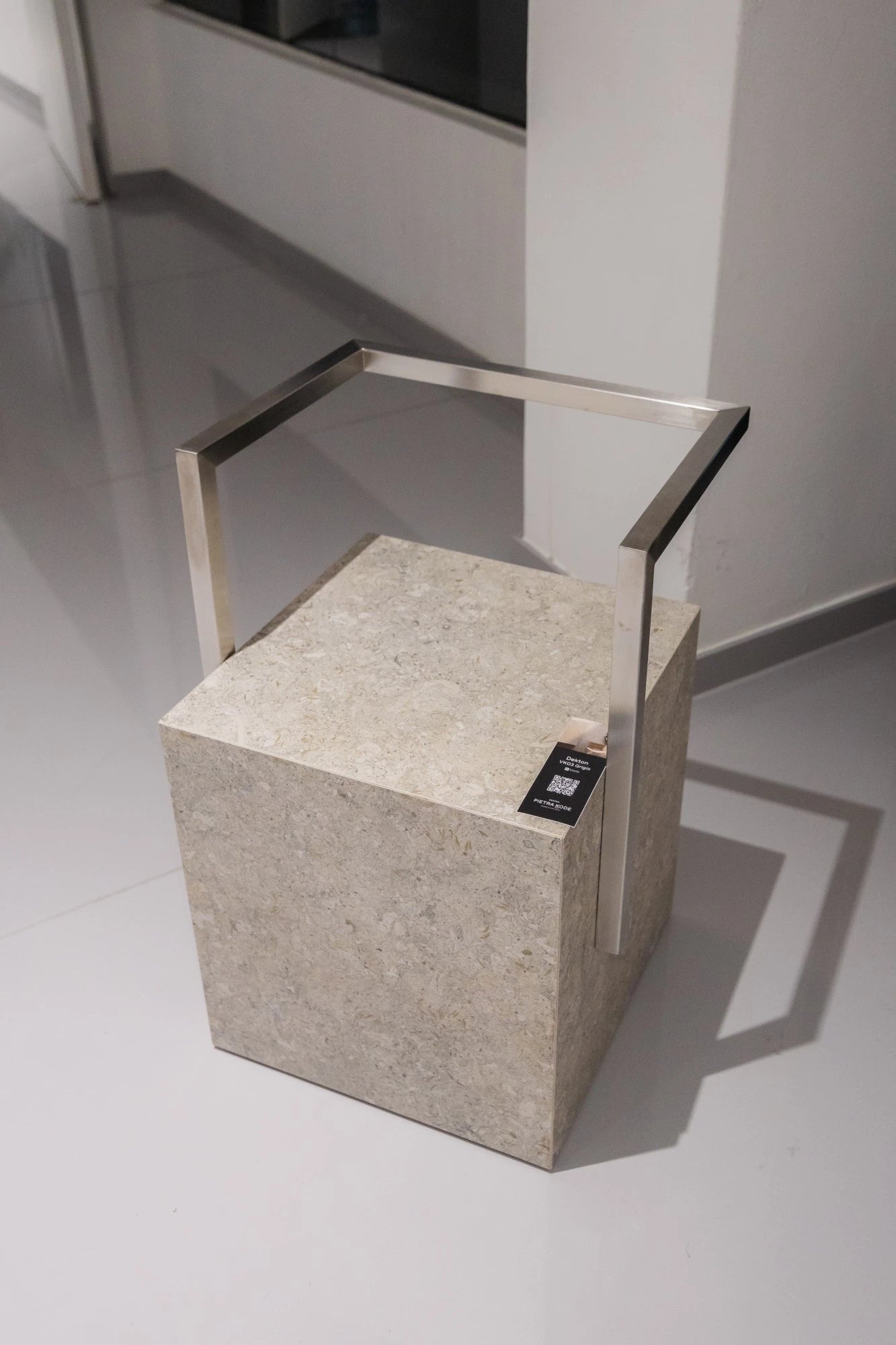 Dekton Vk03 Grigio sample block with polished concrete-like gray finish and metal handle — dekton countertops installed by Signature Stone Las Vegas