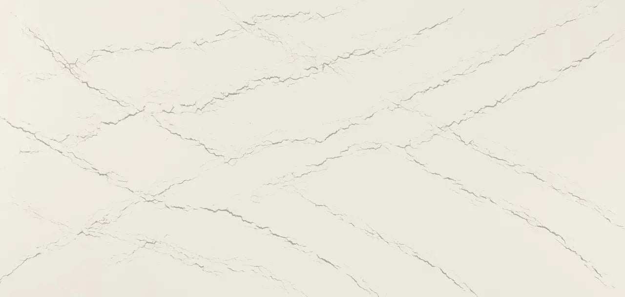 Quartz slab surface with cream background and subtle gray veining throughout — custom countertops fabricated and installed by Signature Stone LV