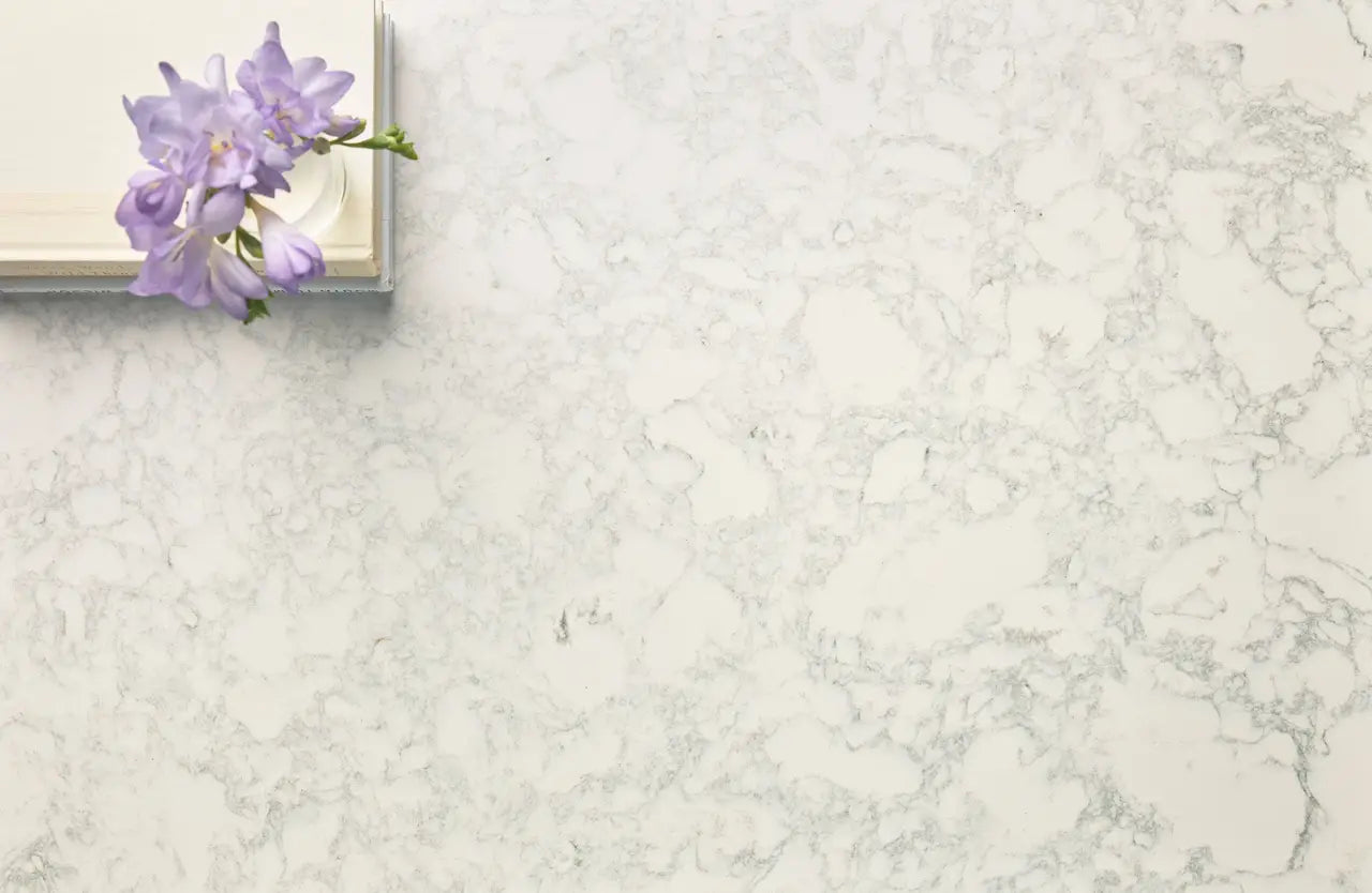 Marble surface with white and gray veining and elegant purple flowers — custom countertops fabricated and installed by Signature Stone LV