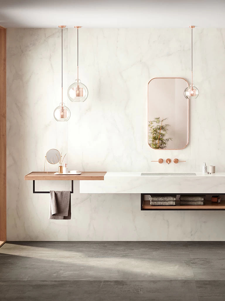 Calacatta Delicato marble bathroom vanity with white veining and polished finish — custom countertops fabricated and installed by Signature Stone LV