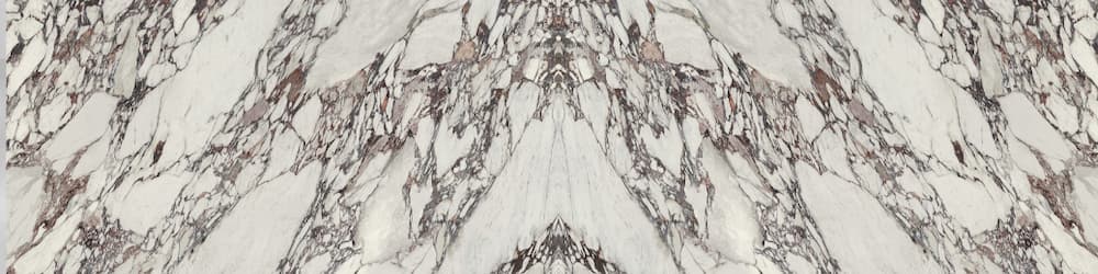 Arabescato Violet marble surface with dramatic white base and purple-gray veining in book-matched pattern — premium countertop fabrication by Signature Stone...