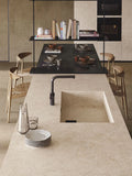 Boost Stone Ivory kitchen island with integrated sink featuring smooth beige finish — premium stone countertops installed by Signature Stone Las Vegas