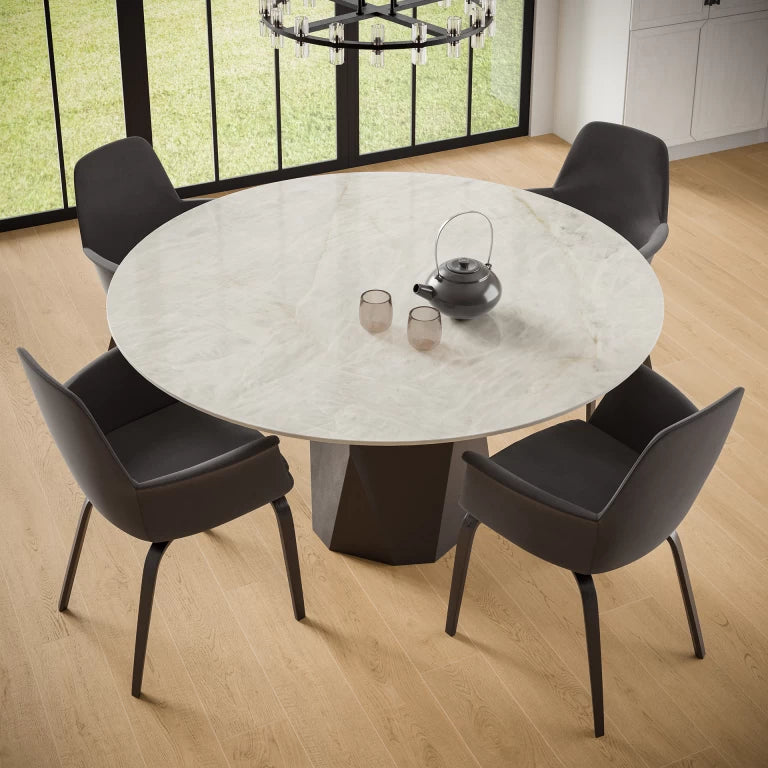 Crystal White quartz round dining table with polished finish and geometric base in modern room — expert countertop fabrication by Signature Stone Las Vegas