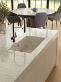 Crystal White quartz kitchen island with integrated sink and polished finish — premium stone countertops installed by Signature Stone Las Vegas