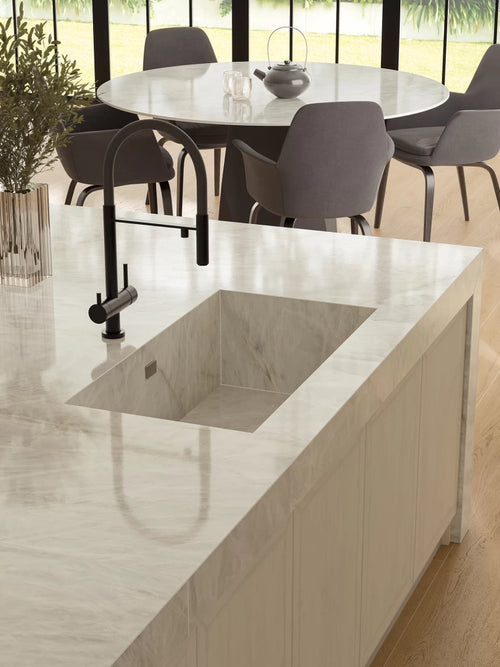 Crystal White quartz kitchen island with integrated sink and polished finish — premium stone countertops installed by Signature Stone Las Vegas