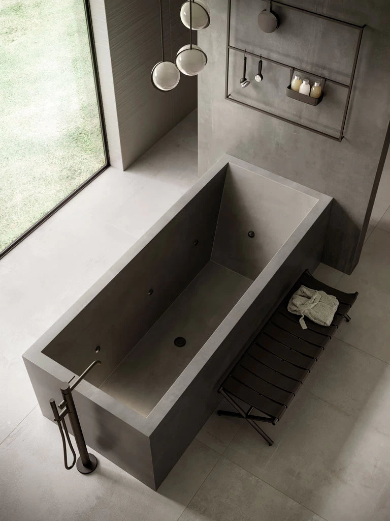 Quartz bathtub surround with sleek gray finish and modern geometric design — custom countertops fabricated and installed by Signature Stone LV
