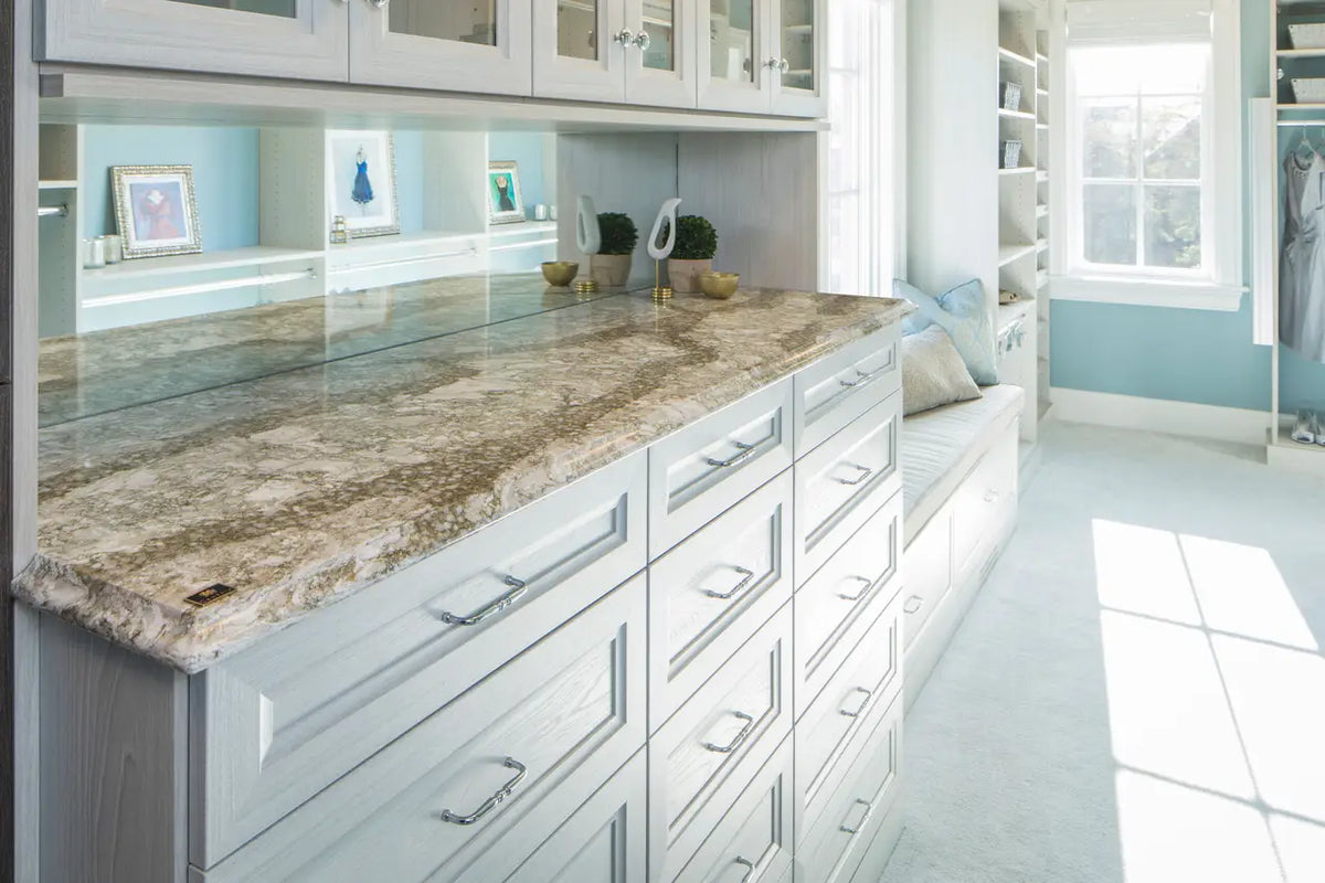 Granite vanity countertops with natural veining and polished finish in white bathroom — custom countertops fabricated and installed by Signature Stone LV