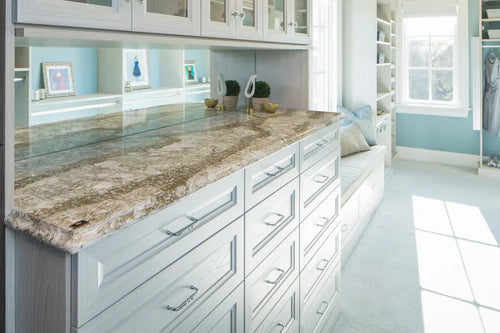 Granite vanity countertops with natural veining and polished finish in white bathroom — custom countertops fabricated and installed by Signature Stone LV