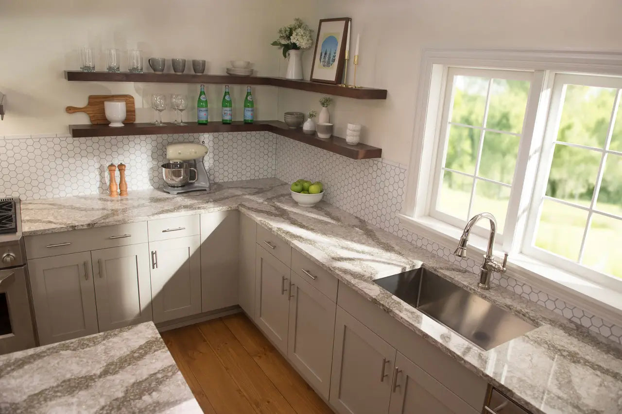 Granite kitchen countertops with white cabinets and hexagon backsplash — elegant stone countertops installed by Signature Stone Las Vegas