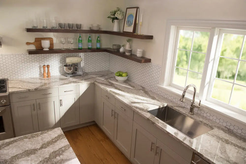 Granite kitchen countertops with white cabinets and hexagon backsplash — elegant stone countertops installed by Signature Stone Las Vegas