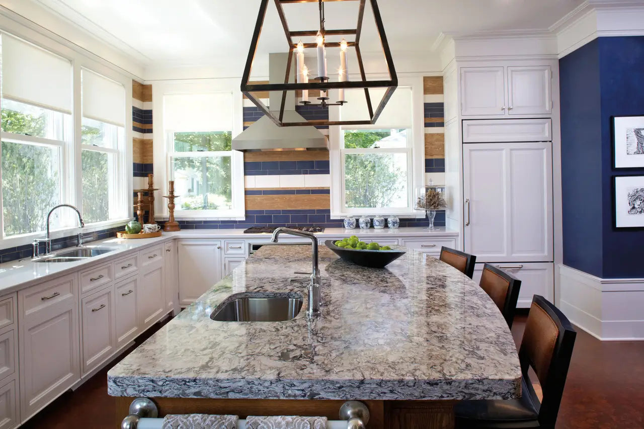 Granite kitchen island and perimeter countertops with dramatic gray veining and polished finish — custom countertops fabricated and installed by Signature St...